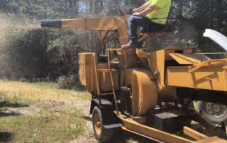 Sweep-Rite – man on wood chipping machine